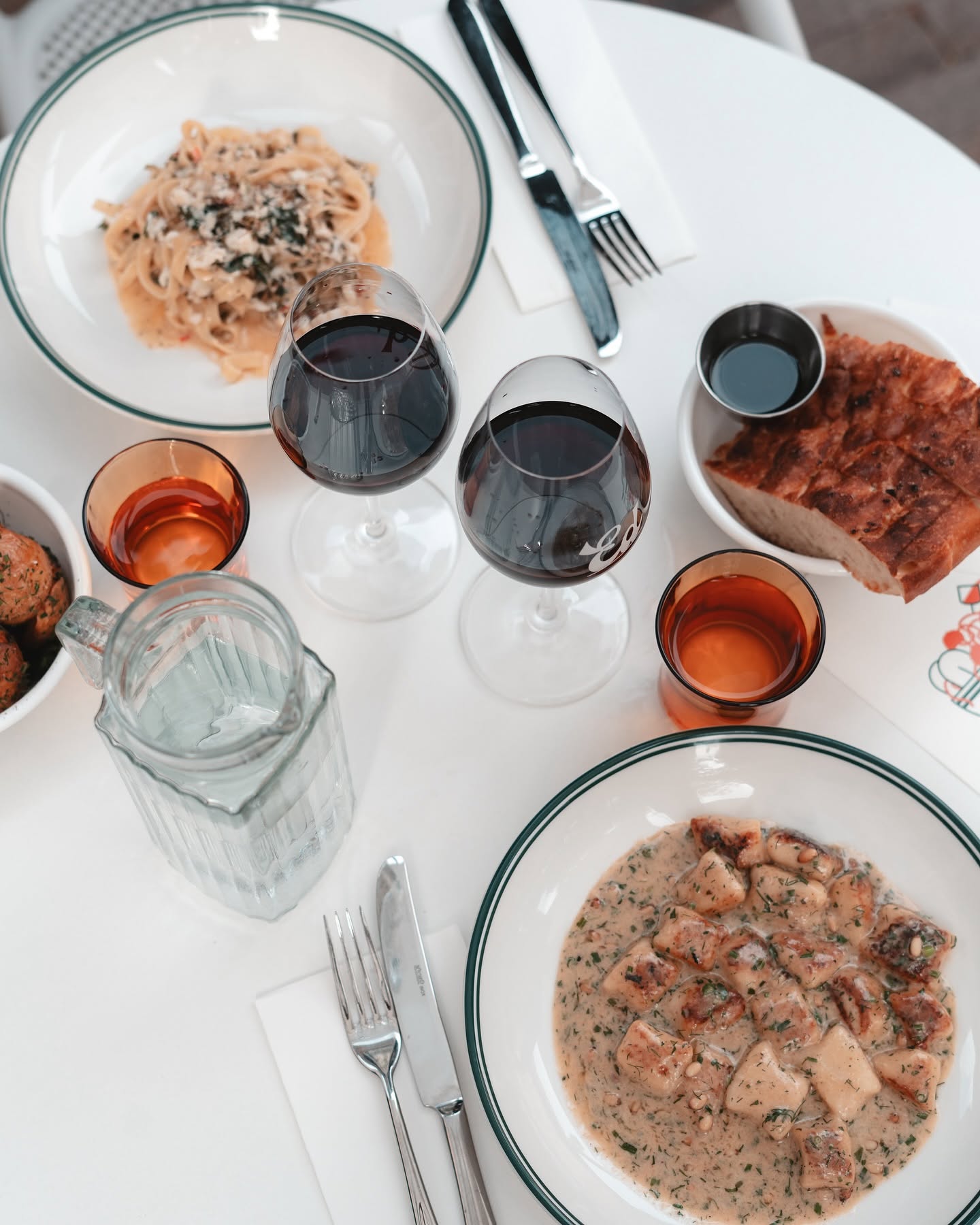 Pasta, gnocchi and red wine on the table at Pasta E Vino